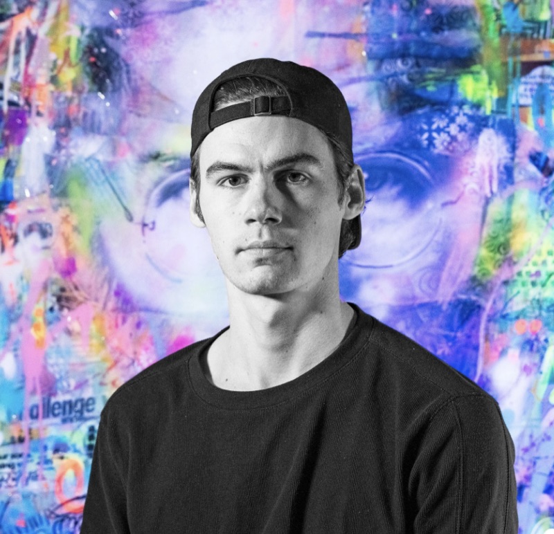 Casey Rickey in front of one of his large paintings